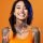 Young woman with neck and face tattoos happy smiling laughing